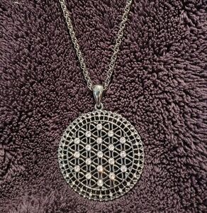 Geometric Filigree Pendant On A Silver Tone Necklace